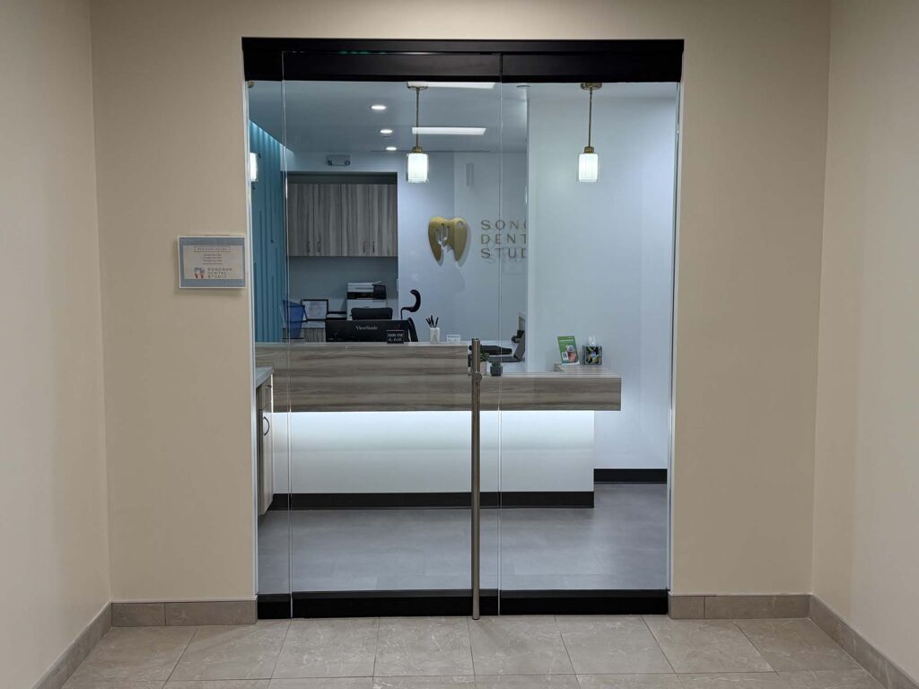 Sonoran Dental Studio reception desk entrance with glass doors and logo
