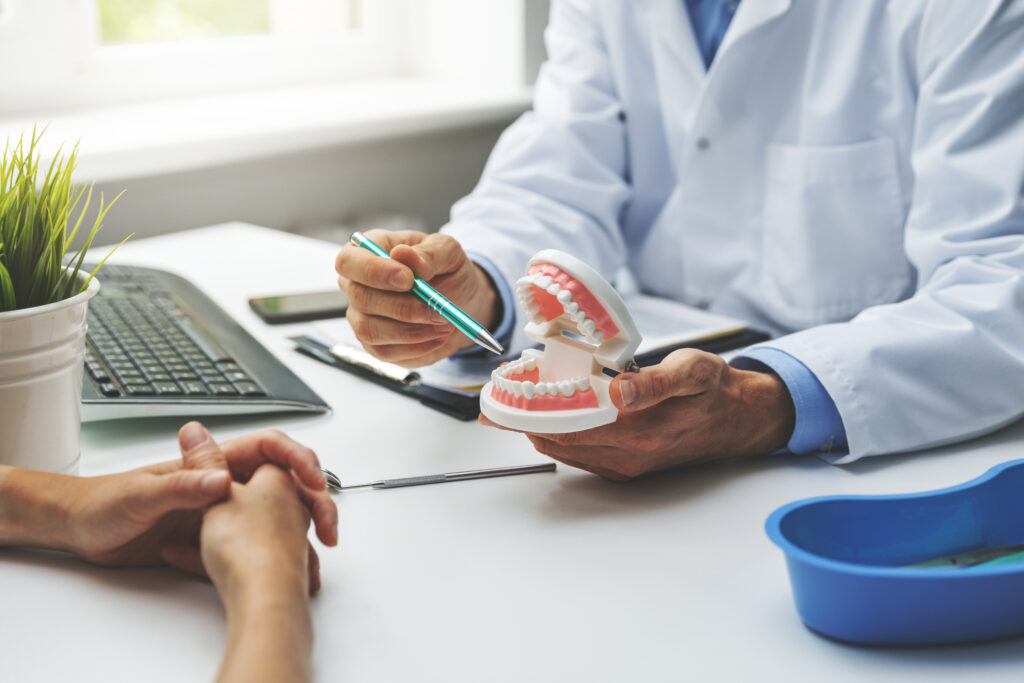 Dentist and patient discussing a planned tooth replacement treatment
