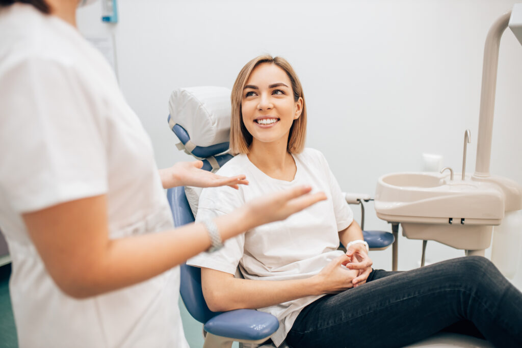 Young woman smiling while waiting for a dental cleaning appointment